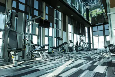 Luxurious high-rise gym with modern equipment and panoramic city views.