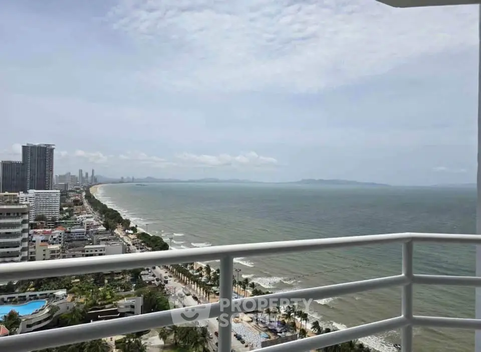 Stunning ocean view from high-rise balcony overlooking cityscape and coastline.
