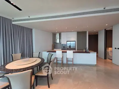 Luxurious open-plan kitchen and dining area with modern design and elegant furnishings.
