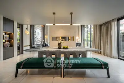 Luxurious modern living room with elegant decor and large windows offering natural light.