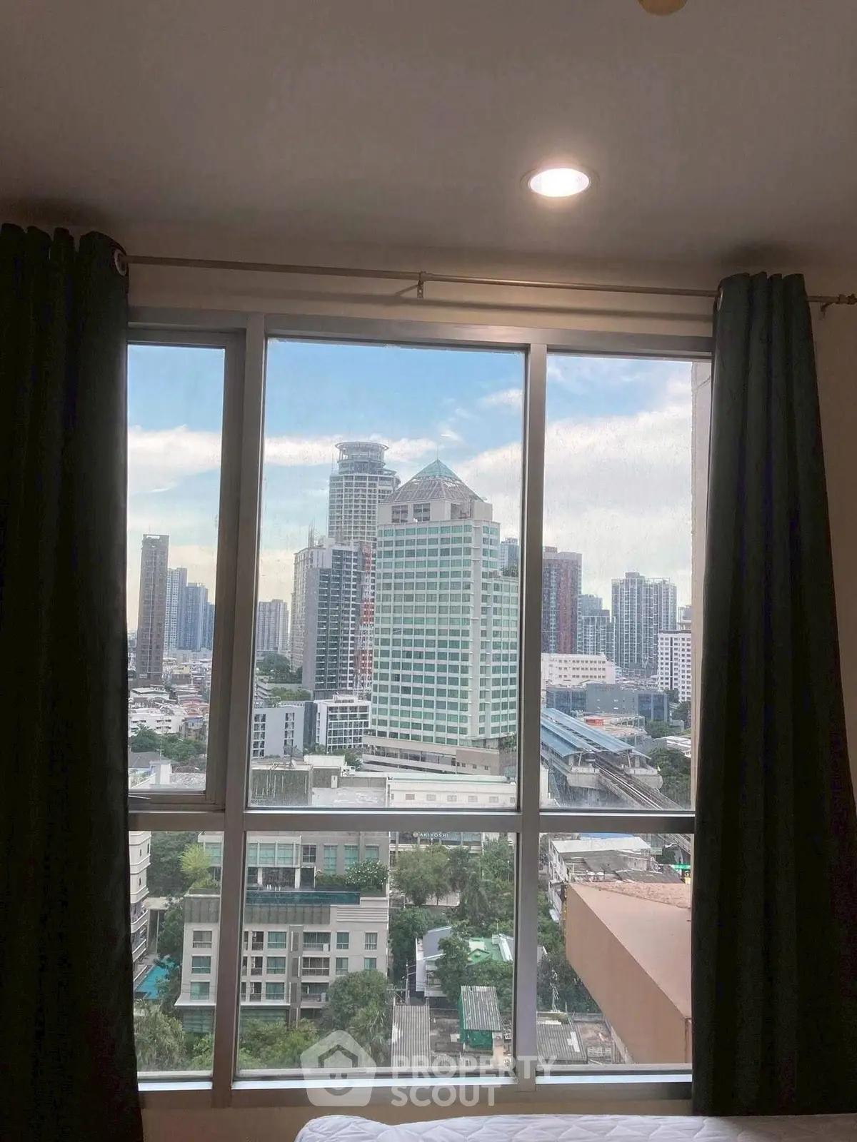 Stunning cityscape view from a high-rise apartment window, showcasing urban living at its finest.