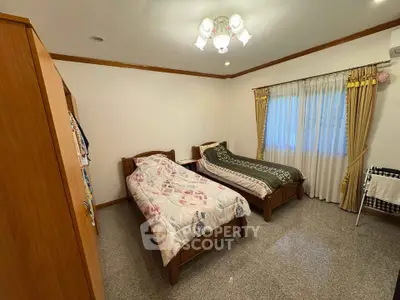 Cozy bedroom with twin beds and elegant lighting in a serene setting.