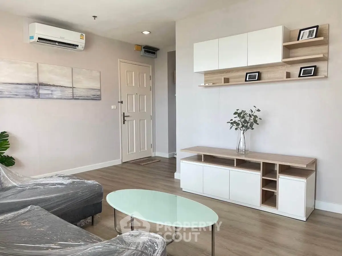 Modern living room with sleek furniture and air conditioning, perfect for comfortable urban living.