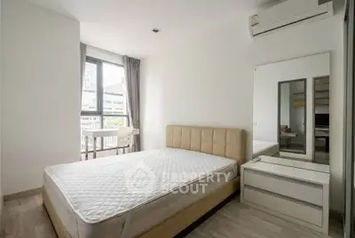 Modern bedroom with large window and air conditioning in urban apartment