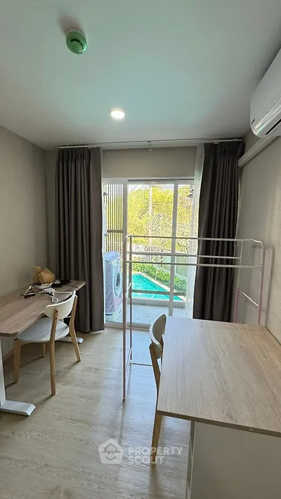 Modern study room with pool view and washing machine on balcony