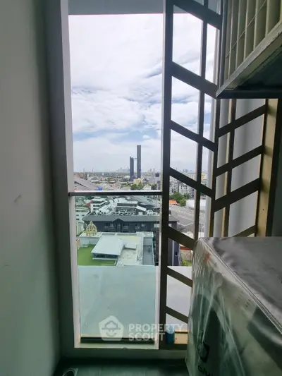 Stunning cityscape view from high-rise balcony with modern railing design.