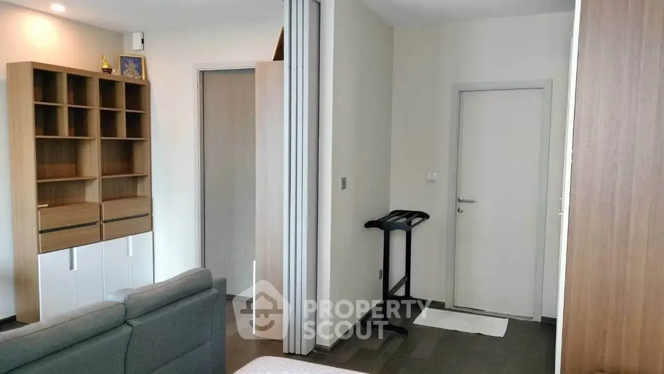 Modern living room with sleek furniture and wooden accents in a cozy apartment.