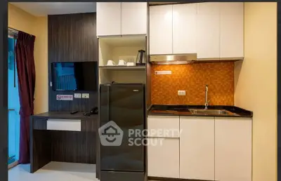 Modern compact kitchen with sleek cabinets and integrated appliances