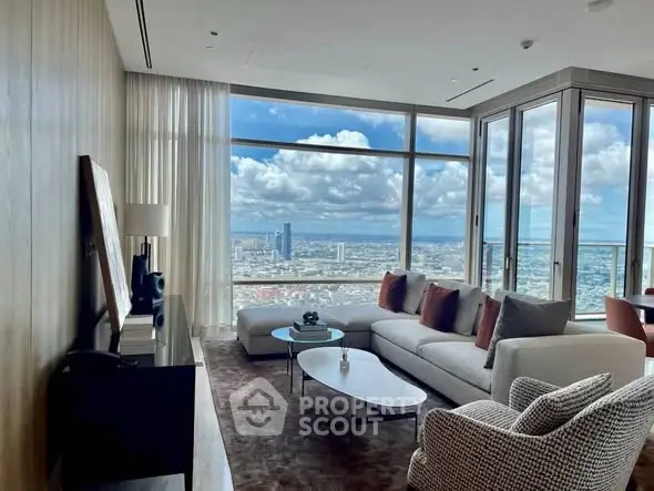 Luxurious living room with panoramic city view and modern furnishings.