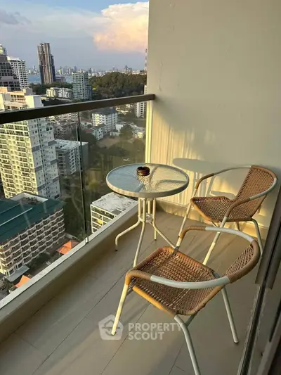 Charming balcony with cityscape view, featuring elegant outdoor seating for relaxation.