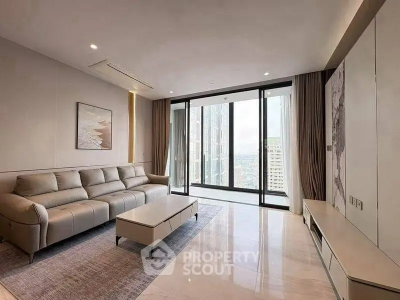 Luxurious modern living room with sleek furniture and stunning city view through large windows.