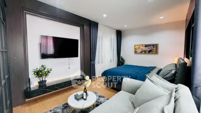 Modern bedroom with stylish decor, featuring a cozy bed, sleek TV setup, and elegant furnishings.