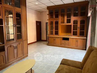 Spacious living room with elegant wooden cabinetry and cozy seating area.