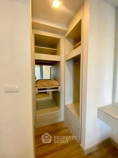 Spacious walk-in closet with wooden shelves and ample storage space.