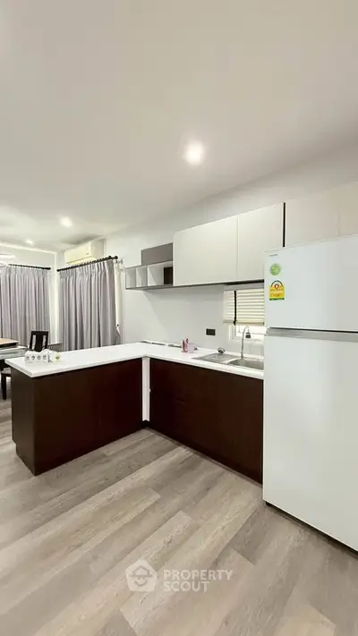 Modern kitchen with sleek cabinetry and spacious layout in a contemporary home.