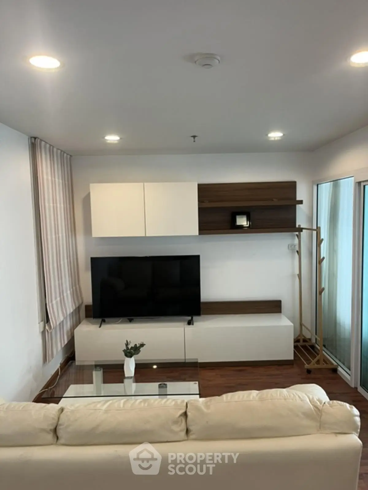 Modern living room with sleek TV setup and stylish shelving