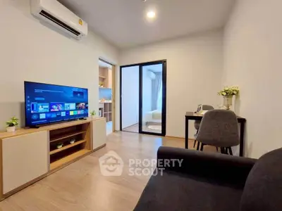 Modern living room with sleek TV setup and cozy seating area, perfect for relaxation and entertainment.