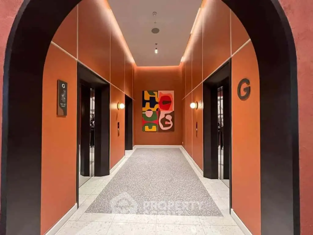Stylish modern elevator lobby with vibrant artwork and sleek design.
