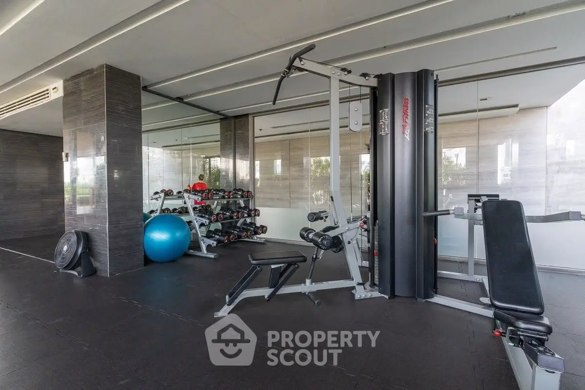 Modern gym with state-of-the-art equipment in luxury residential building.