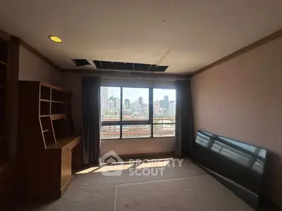 Spacious room with city view and built-in wooden desk, ideal for home office setup.