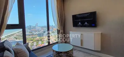 Luxurious living room with stunning city and ocean view from high-rise apartment.