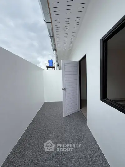 Modern minimalist balcony with open door and sleek design