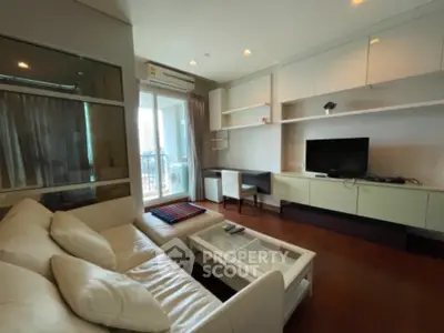 Modern living room with sleek furniture and balcony view in a stylish apartment.