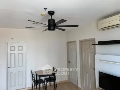 Modern living room with ceiling fan and minimalist furniture