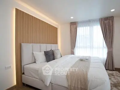 Luxurious bedroom with elegant decor and natural light, featuring a cozy bed and stylish curtains.