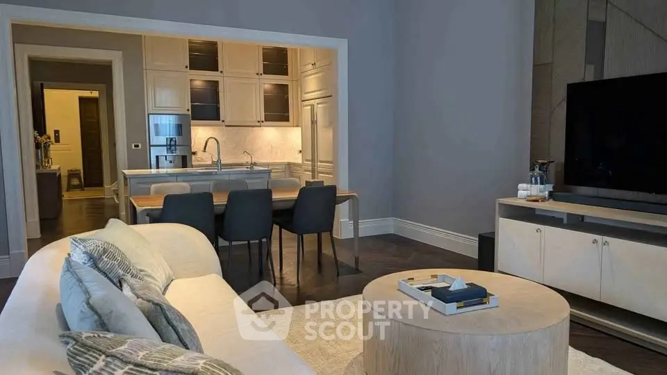 Modern open-layout living room with sleek kitchen and stylish decor