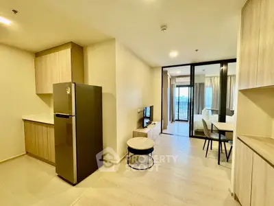 Modern open-plan living room with kitchen and bedroom view