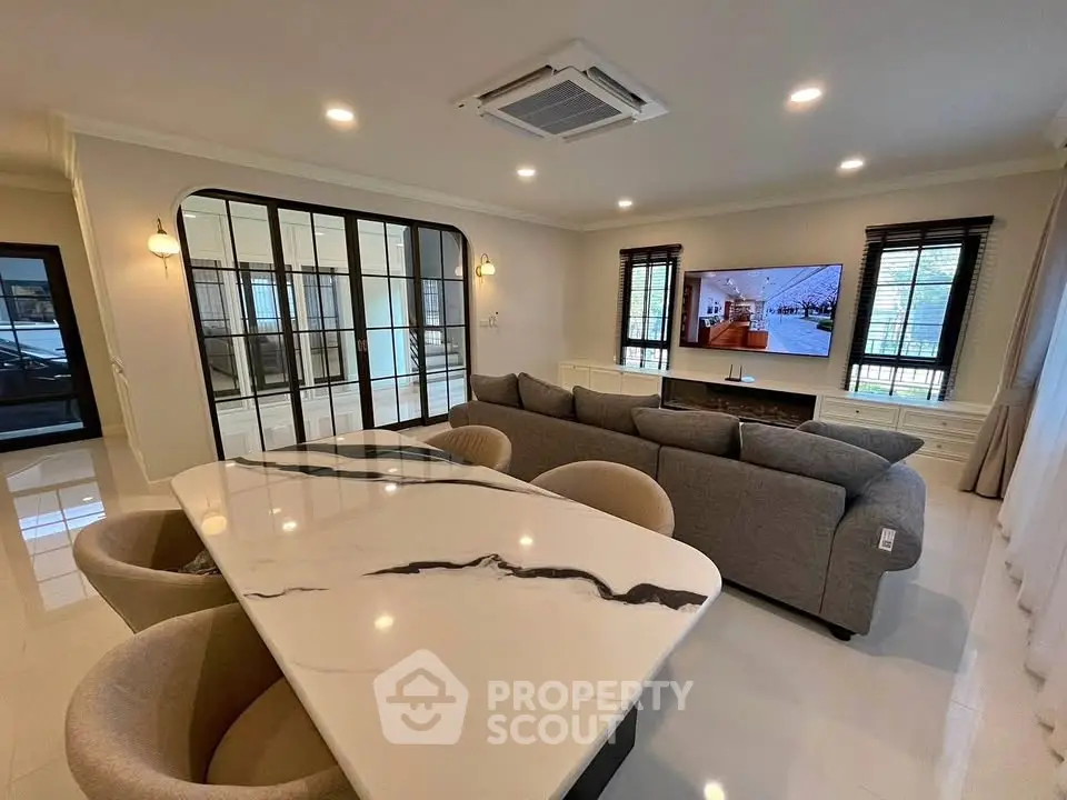 Luxurious living room with modern decor, spacious seating, and elegant marble dining table.
