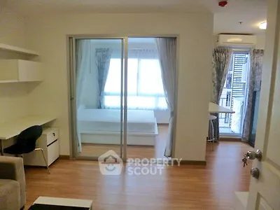 Modern apartment interior with sliding glass doors and wooden flooring