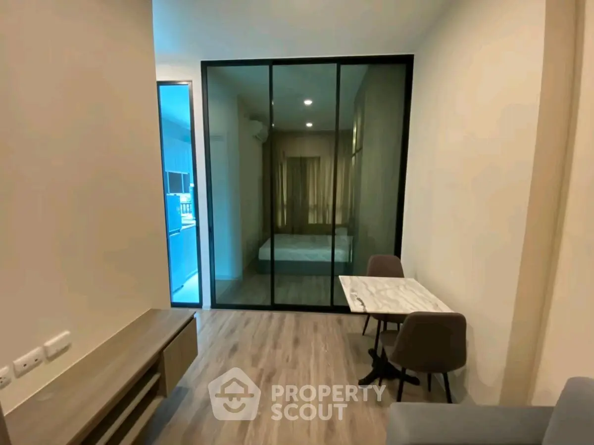 Modern studio apartment with glass partition and stylish furnishings