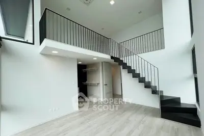 Modern duplex apartment with sleek staircase and open layout