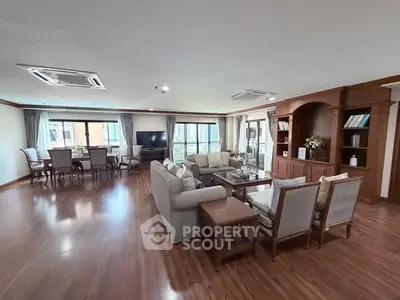 Spacious living room with elegant furniture and large windows in a luxury apartment.
