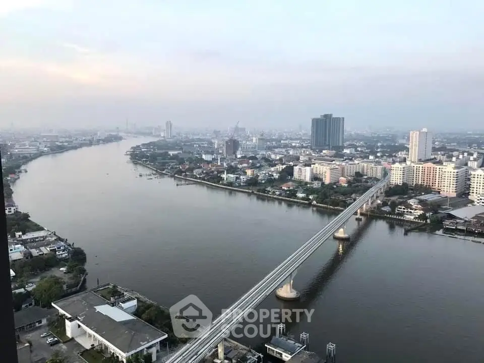 Stunning cityscape view with river and bridge, showcasing urban skyline and serene waterway.