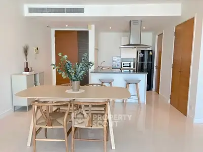 Modern open-plan kitchen and dining area with sleek design and natural light.