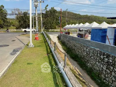 Scenic outdoor view with stone wall and tents, ideal for commercial use