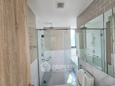 Modern bathroom with glass shower and sleek tile design