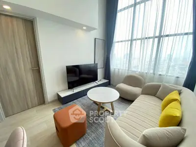 Modern living room with stylish furniture and large windows offering city views.