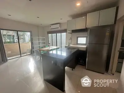 Modern kitchen with sleek black island and stainless steel appliances