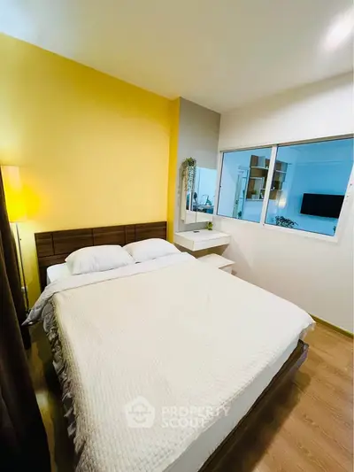 Cozy modern bedroom with yellow accent wall and large window