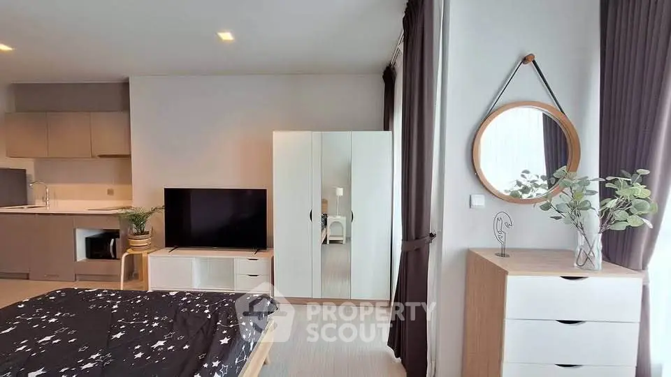 Modern studio apartment with stylish decor and open kitchen layout