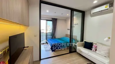 Modern apartment with cozy living room and bedroom, featuring a balcony and stylish decor.
