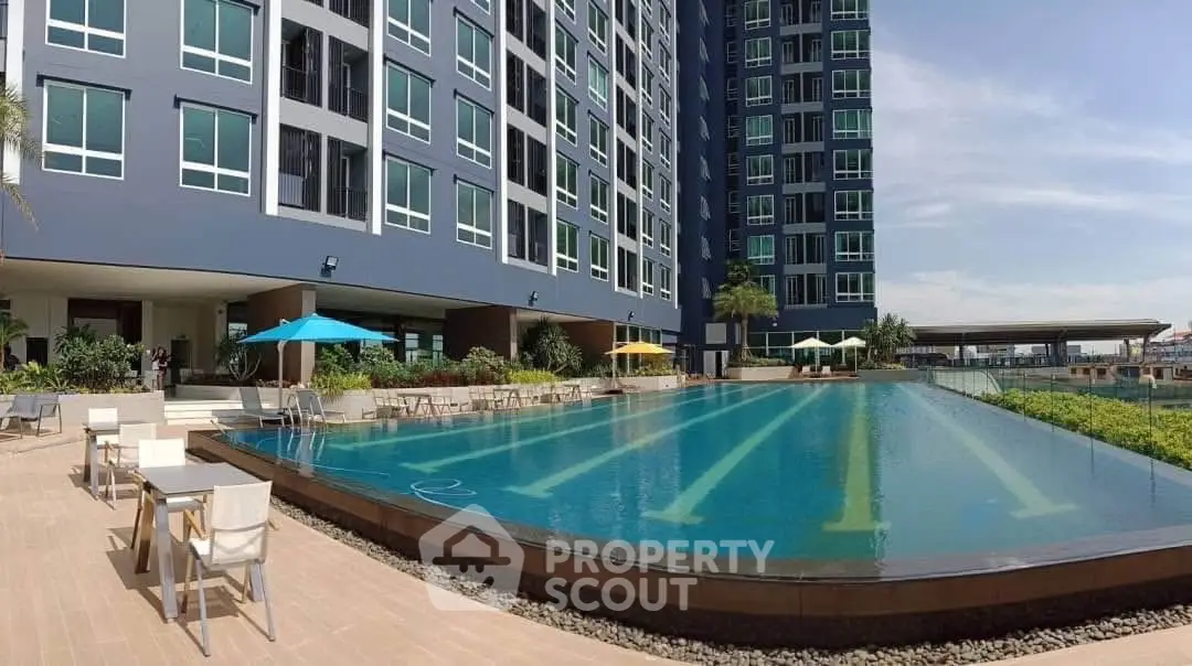 Luxurious high-rise building with stunning poolside view and modern amenities.