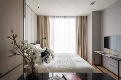 Elegant bedroom with modern decor, large window, and stylish furnishings for a cozy living experience.