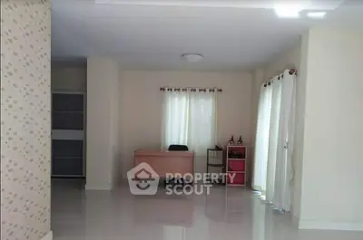 Spacious interior with desk and natural light, ideal for home office setup.