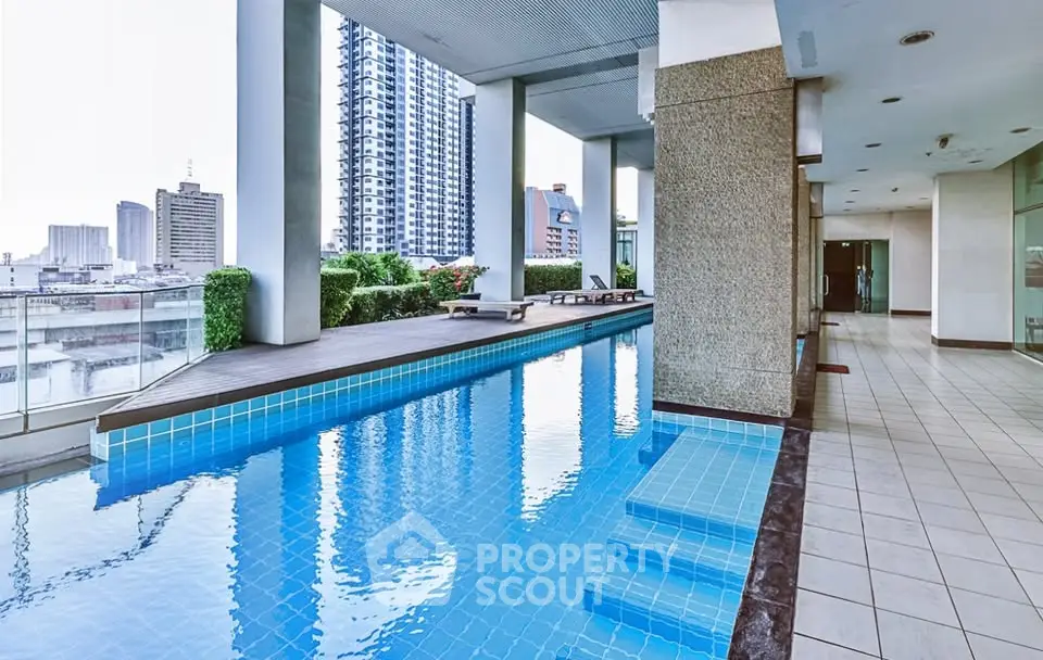 Luxurious high-rise building with stunning rooftop pool and city views, perfect for urban living.
