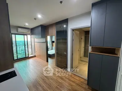 Modern apartment interior with open layout, wooden flooring, and balcony view.